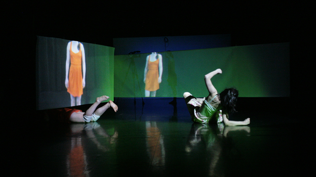Warner and Theodorou dance under, around and through the projected images