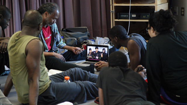 Reggie Wilson watches video with Fist and Heel Performance Group