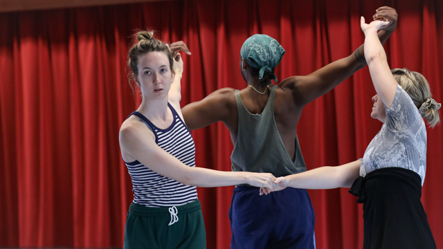 Judkins, Lloyd, and Young partner up in a trio to perform interconnected choreography in the dance studio