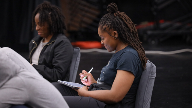 Naimah Petigny taking notes during a group discussion