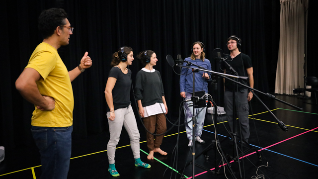 Musician, Daniel Corall, and dancers in vocal recording session