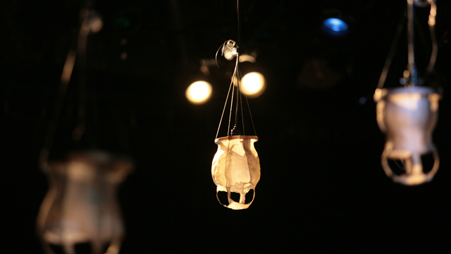 Emily Johnson's fish skin lanterns hang in the Black Box Studio.