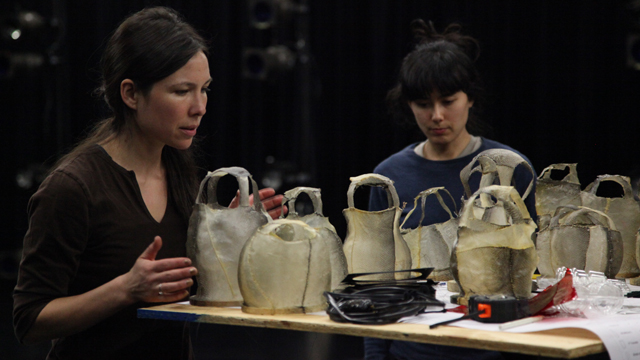 Emily Johnson and performer Aretha Aoki prep the lanterns to be hung.